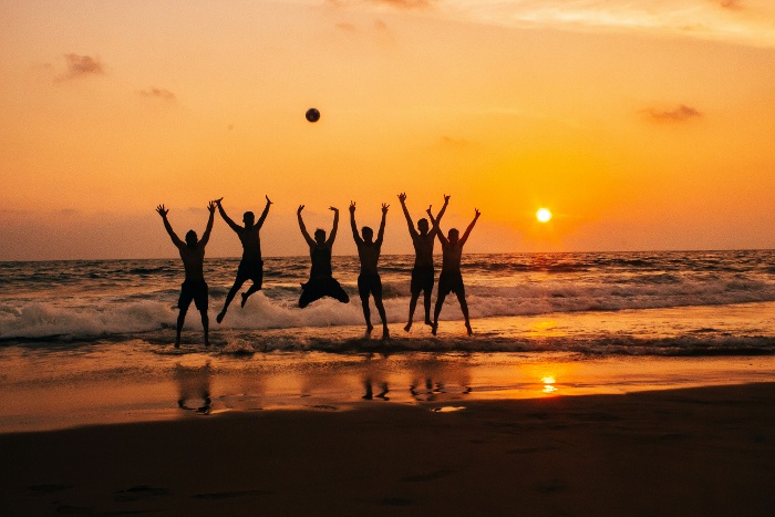 friends on the beach at sunset
