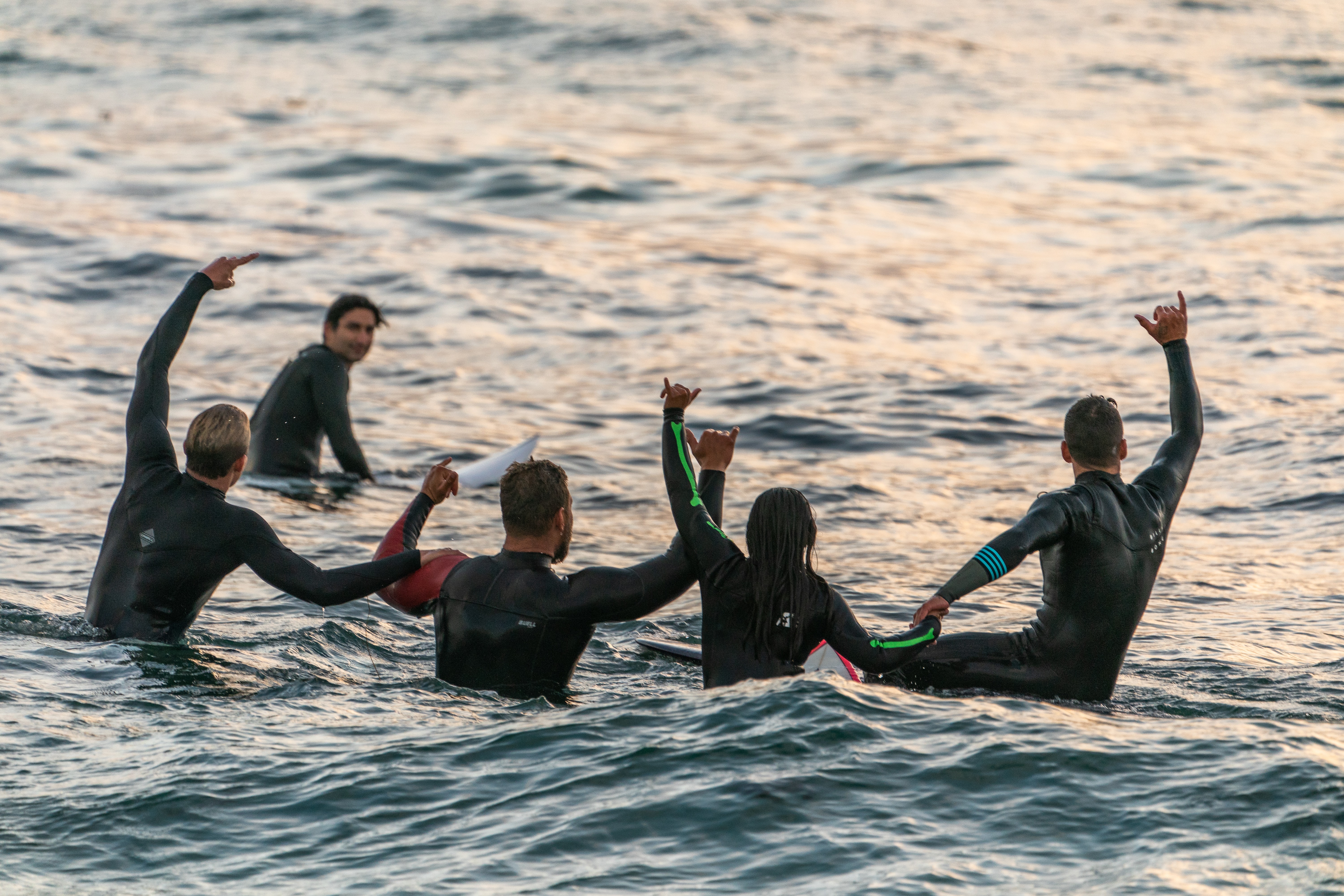 surfer at dusk riding a wave as a metaphor for a HubSpot portal audit